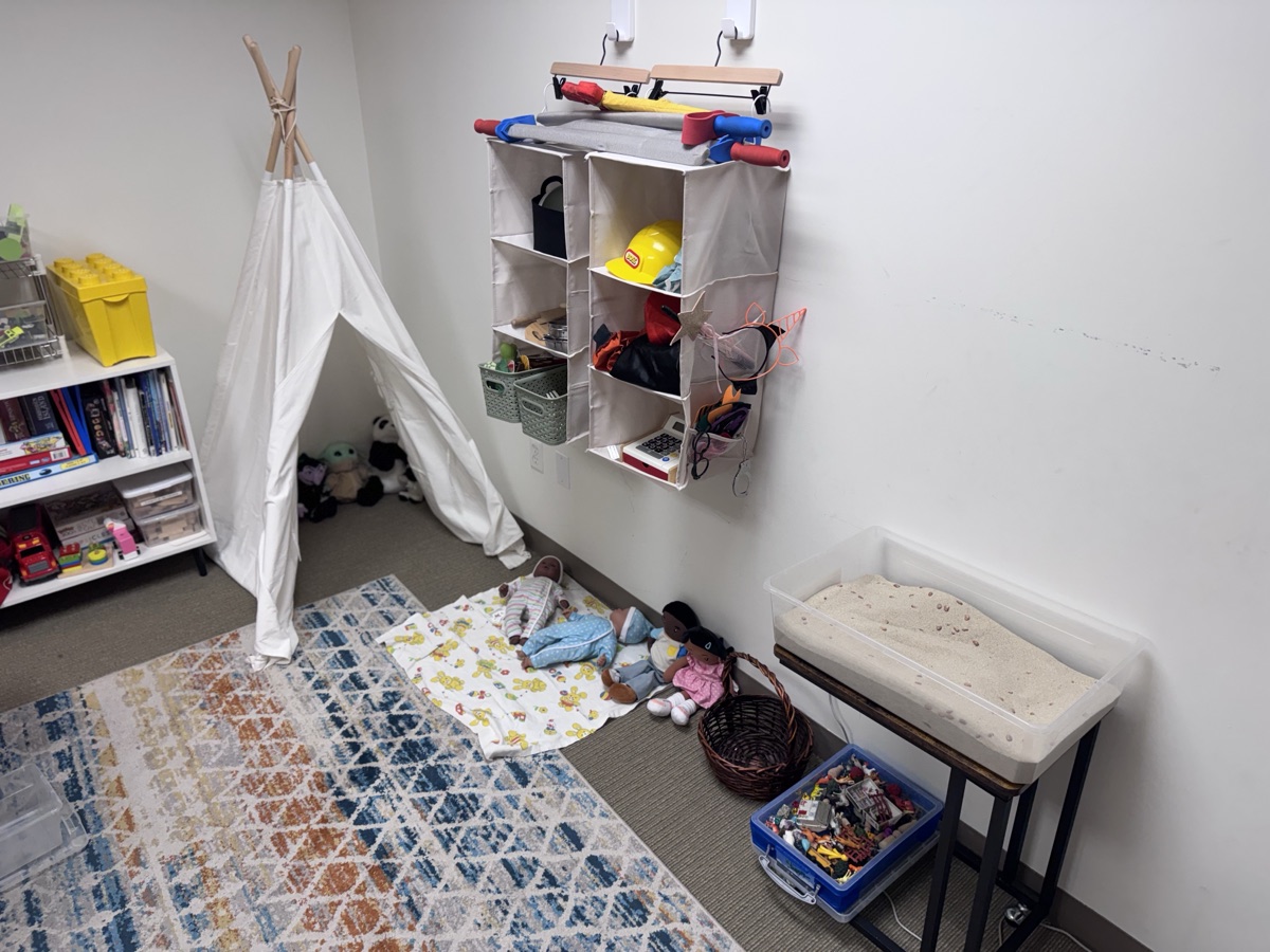 The playroom, with a teepee and shelves of toys
